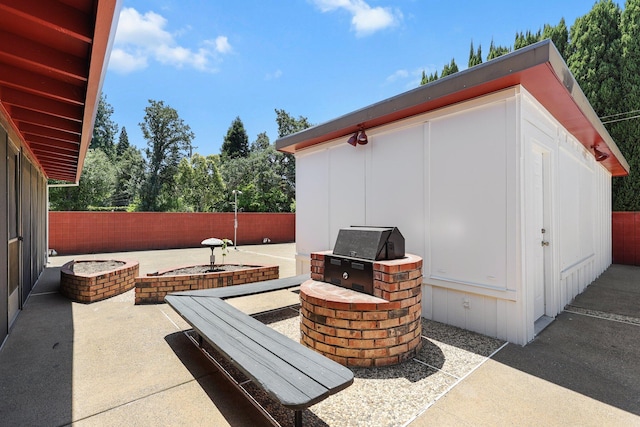 910 Hallmark Dr, Redding, CA 96001 - fenced backyard with a fire pit, a patio area, exterior kitchen, and an outdoor structure
