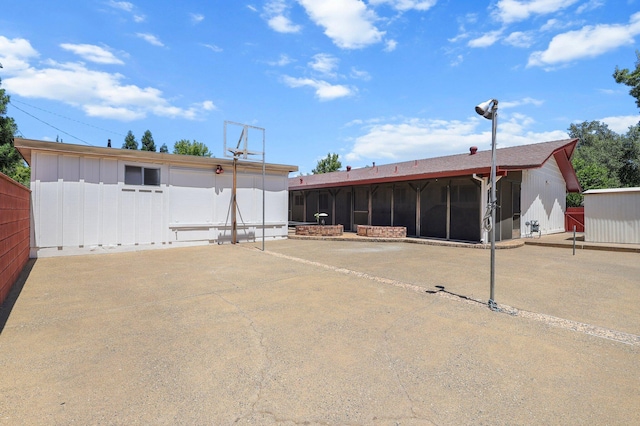910 Hallmark Dr, Redding, CA 96001 - rear view of house featuring a sunroom, an outdoor structure, and board and batten siding