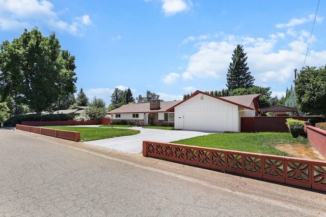 910 Hallmark Dr, Redding, CA 96001 - ranch-style house with concrete driveway, an attached garage, and a chimney