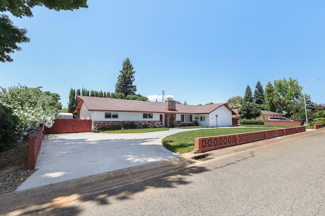 910 Hallmark Dr, Redding, CA 96001 - ranch-style house with driveway, a chimney, and stone siding