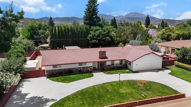 910 Hallmark Dr, Redding, CA 96001 - view of front of property with curved driveway, a mountain view, a gate, and a chimney