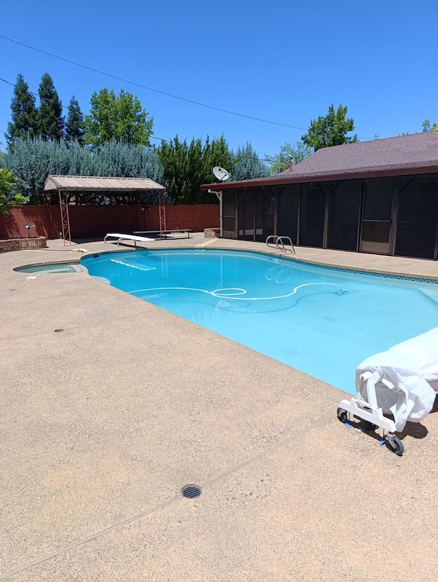 910 Hallmark Dr, Redding, CA 96001 - view of swimming pool with a sunroom, a fenced backyard, and a patio