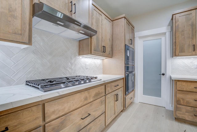 19450 Vista Del Monte Ct, Redding, CA 96003 - kitchen with range hood, appliances with stainless steel finishes, tasteful backsplash, light stone countertops, and light wood-style floors