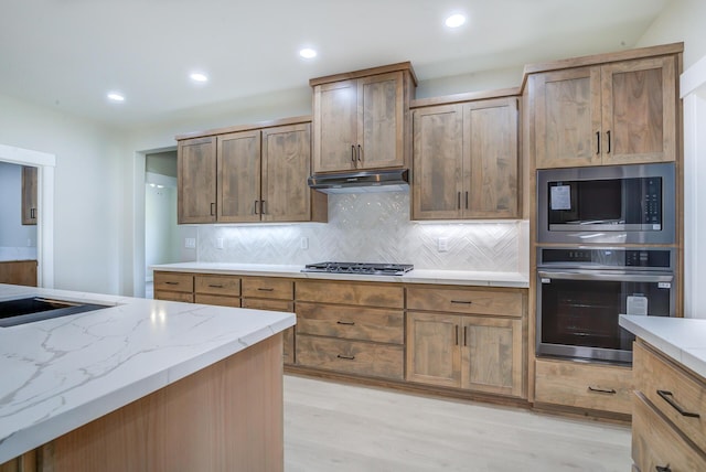 19450 Vista Del Monte Ct, Redding, CA 96003 - kitchen with appliances with stainless steel finishes, under cabinet range hood, light wood-type flooring, tasteful backsplash, and recessed lighting