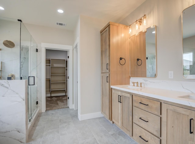 19450 Vista Del Monte Ct, Redding, CA 96003 - bathroom featuring a marble finish shower, marble look tile flooring, double vanity, a spacious closet, and recessed lighting