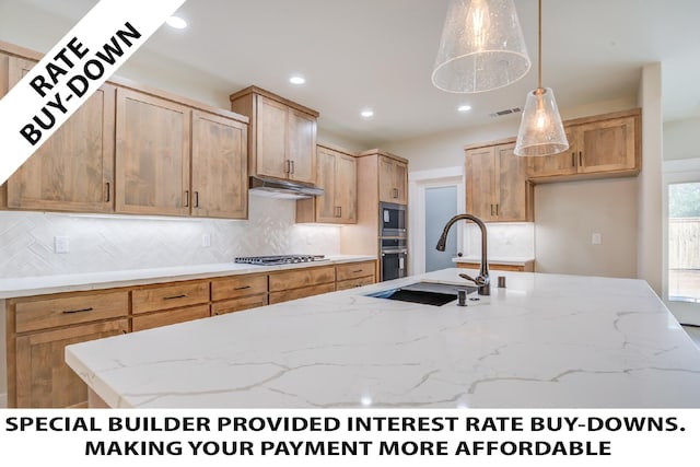 19450 Vista Del Monte Ct, Redding, CA 96003 - kitchen with stainless steel appliances, under cabinet range hood, light stone countertops, decorative backsplash, and recessed lighting