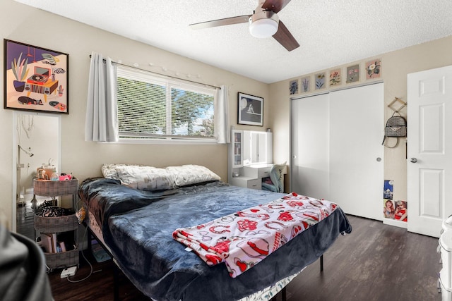 2647 Shasta View Dr, Redding, CA 96002 - bedroom with a textured ceiling, a closet, dark wood-type flooring, and ceiling fan