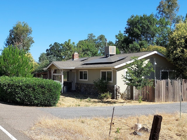 2827 Stingy Ln, Anderson, CA 96007 - ranch-style house featuring stone siding, solar panels, a chimney, and roof with shingles