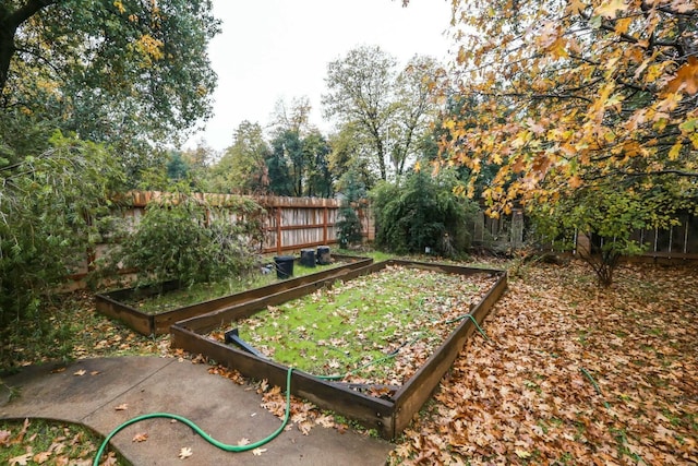 3466 Silverwood St, Redding, CA 96002 - fenced backyard featuring a garden and view of scattered trees