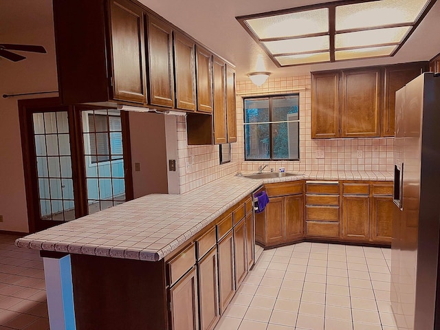 3466 Silverwood St, Redding, CA 96002 - kitchen featuring light tile patterned floors, stainless steel appliances, backsplash, and tile counters