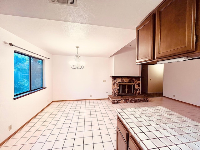 3466 Silverwood St, Redding, CA 96002 - unfurnished living room with a chandelier, a fireplace, and light tile patterned flooring