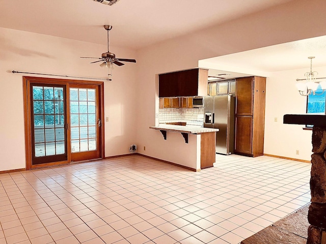 3466 Silverwood St, Redding, CA 96002 - kitchen featuring appliances with stainless steel finishes, a peninsula, a breakfast bar area, a chandelier, and tasteful backsplash