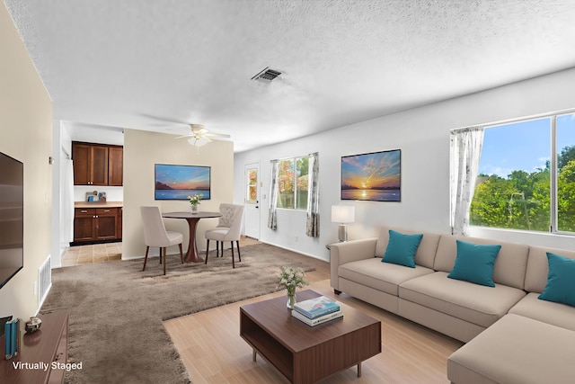 1333 Deborah Dr, Red Bluff, CA 96080 - living room featuring a ceiling fan, light carpet, and a textured ceiling