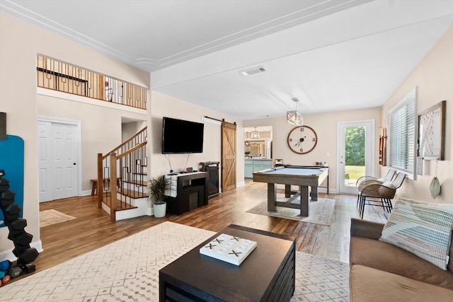 4676 Dandelion Dr, Redding, CA 96002 - living area with a barn door, pool table, stairs, and wood finished floors