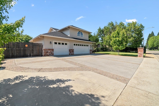 4676 Dandelion Dr, Redding, CA 96002 - view of property exterior with driveway, brick siding, and an attached garage