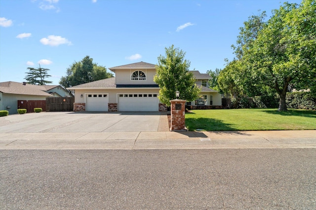 4676 Dandelion Dr, Redding, CA 96002 - view of front of property featuring concrete driveway, a garage, and stone siding