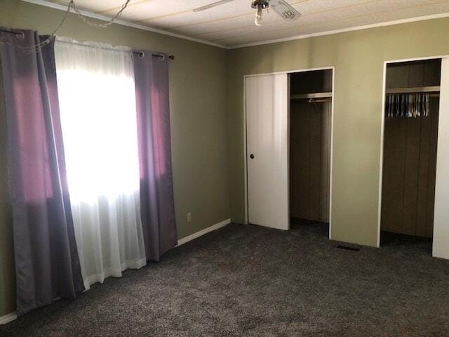 1064 Eagle Nest Rd, Redding, CA 96003 - unfurnished bedroom with two closets, carpet flooring, and ornamental molding