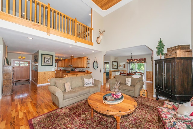 100 Eleanore Ln, Trinity Center, CA 96091 - living area with a chandelier, light wood-style flooring, a high ceiling, and wainscoting