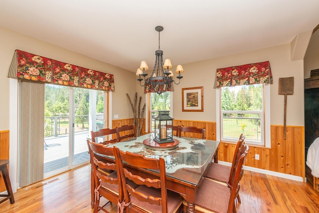 100 Eleanore Ln, Trinity Center, CA 96091 - dining area with wainscoting, light wood-style flooring, a chandelier, and wood walls