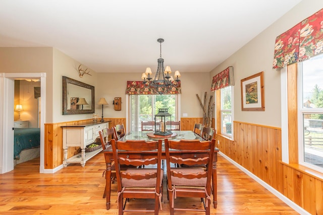 100 Eleanore Ln, Trinity Center, CA 96091 - dining room featuring wainscoting, wood walls, light wood finished floors, and a chandelier