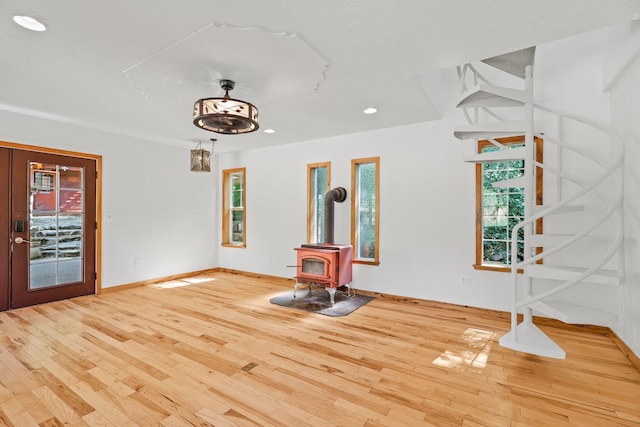 19250 Coal Creek Rd, Lakehead, CA 96051 - unfurnished living room featuring a wood stove, plenty of natural light, hardwood / wood-style flooring, and recessed lighting