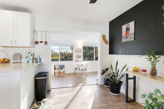 3055 Ryan Ln, Redding, CA 96003 - hallway with light wood finished floors and a wainscoted wall