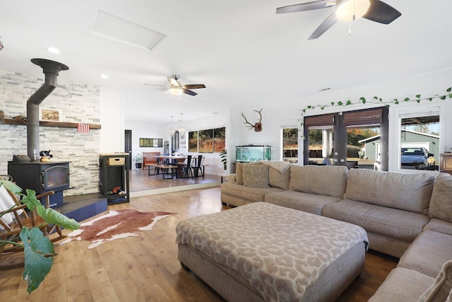 3055 Ryan Ln, Redding, CA 96003 - living area featuring a wood stove, a ceiling fan, wood finished floors, and recessed lighting