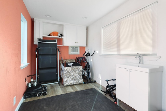 3055 Ryan Ln, Redding, CA 96003 - exercise area with wood finished floors, a wall mounted air conditioner, healthy amount of natural light, and recessed lighting