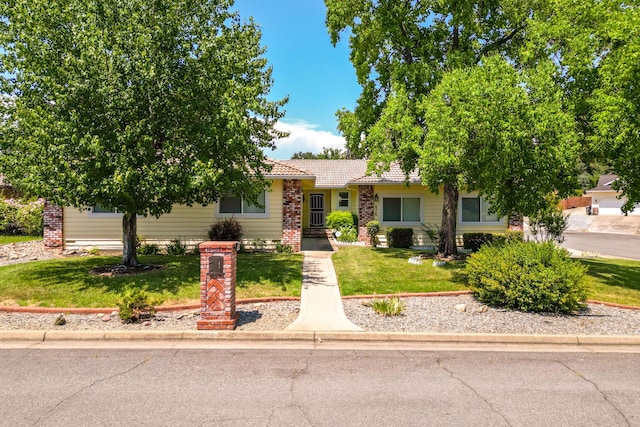 676 Country Oak Dr, Redding, CA 96003 - view of front of house featuring a front lawn, a tiled roof, and brick siding