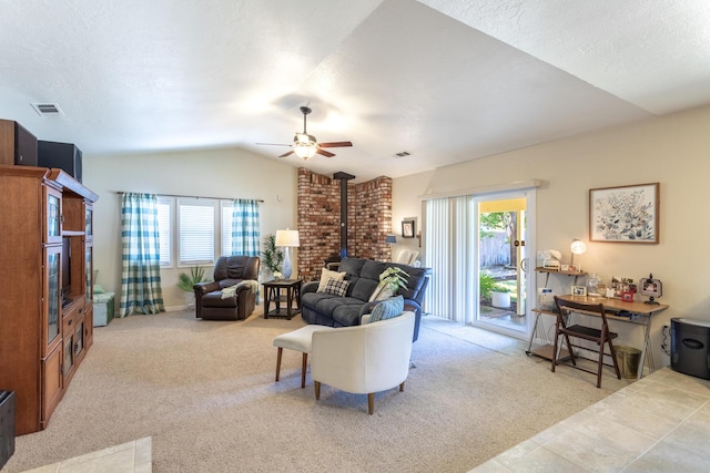 676 Country Oak Dr, Redding, CA 96003 - carpeted living room with a wood stove, lofted ceiling, a ceiling fan, and a textured ceiling