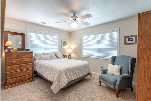 676 Country Oak Dr, Redding, CA 96003 - bedroom with multiple windows, light colored carpet, and a ceiling fan