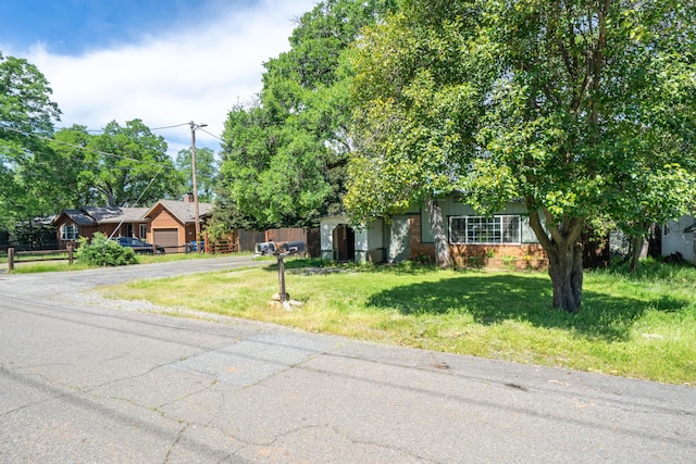 1440 Oakdale Ln, Redding, CA 96002 - obstructed view of property featuring asphalt driveway and a front lawn