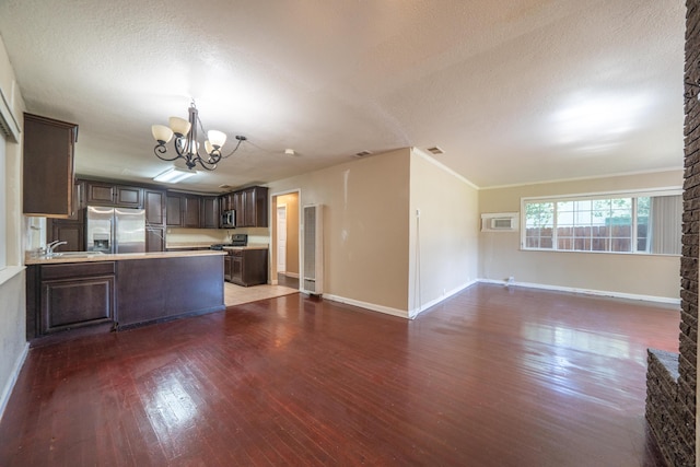 1440 Oakdale Ln, Redding, CA 96002 - kitchen featuring appliances with stainless steel finishes, open floor plan, dark brown cabinetry, a chandelier, and wood finished floors
