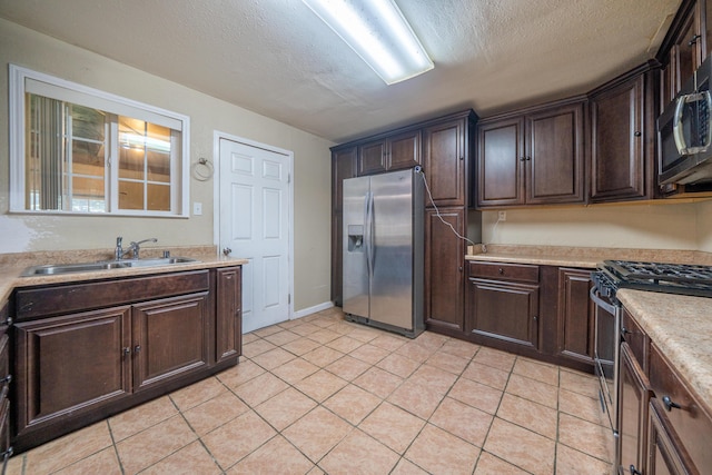 1440 Oakdale Ln, Redding, CA 96002 - kitchen with stainless steel appliances, dark brown cabinetry, light countertops, light tile patterned floors, and a textured ceiling