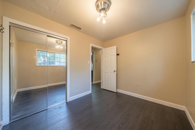 1440 Oakdale Ln, Redding, CA 96002 - unfurnished bedroom featuring dark wood-style flooring and a closet