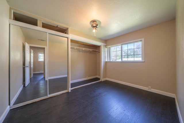 1440 Oakdale Ln, Redding, CA 96002 - unfurnished bedroom featuring dark wood-type flooring and a closet