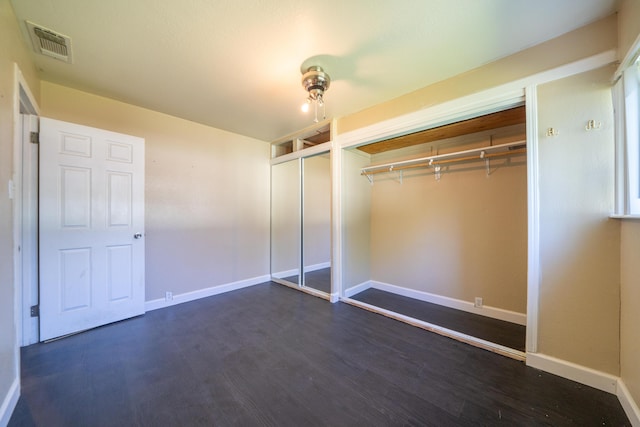 1440 Oakdale Ln, Redding, CA 96002 - unfurnished bedroom featuring dark wood-style floors and multiple closets