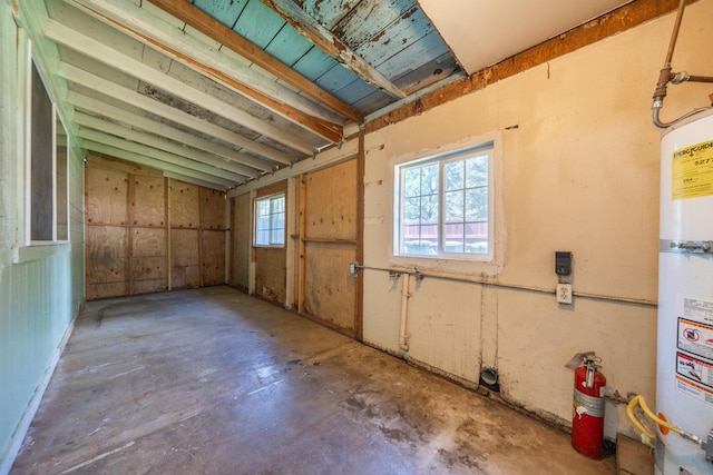 1440 Oakdale Ln, Redding, CA 96002 - miscellaneous room featuring unfinished concrete flooring, water heater, and a garage