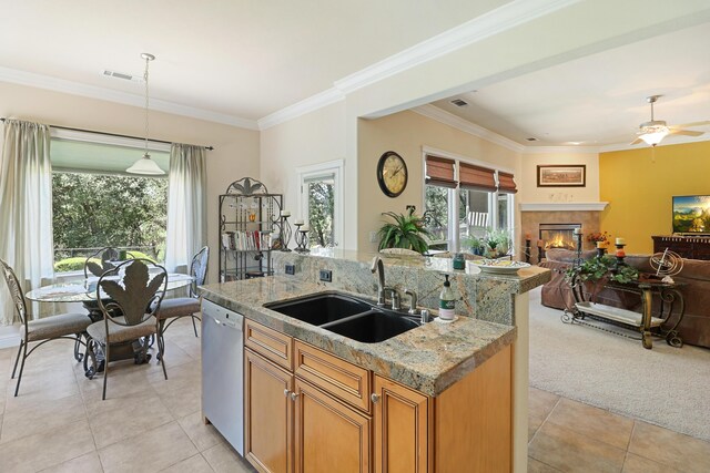1835 Dellwood Dr, Redding, CA 96003 - kitchen with light tile patterned flooring, open floor plan, dishwashing machine, a tiled fireplace, and crown molding