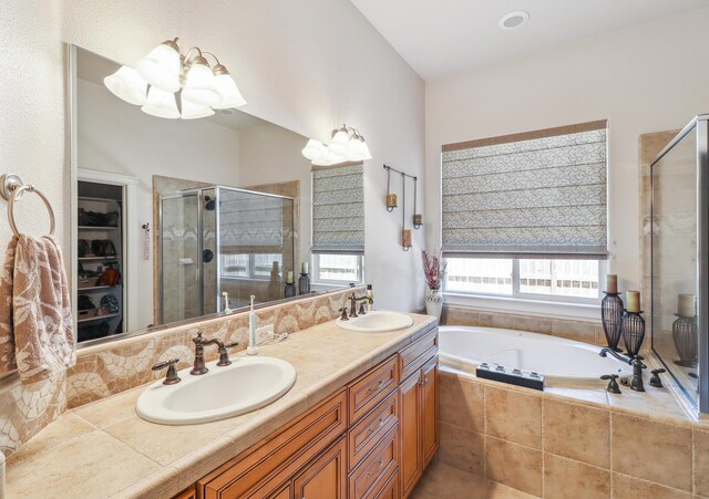 1835 Dellwood Dr, Redding, CA 96003 - full bath with a shower stall, a bath, double vanity, a chandelier, and a walk in closet