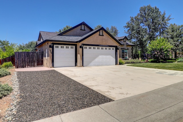 1835 Dellwood Dr, Redding, CA 96003 - view of front facade with an attached garage, stucco siding, concrete driveway, and a shingled roof