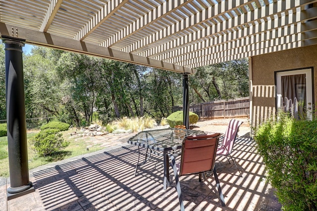 1835 Dellwood Dr, Redding, CA 96003 - view of patio / terrace with outdoor dining area, a pergola, and view of wooded area