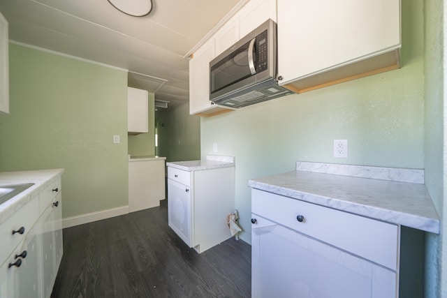 1430 Oakdale Ln, Redding, CA 96003 - kitchen with stainless steel microwave, dark wood-style flooring, and white cabinetry