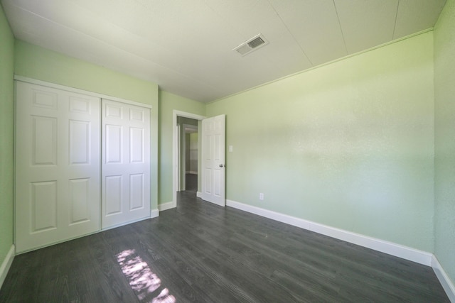 1430 Oakdale Ln, Redding, CA 96003 - unfurnished bedroom featuring dark wood finished floors and a closet