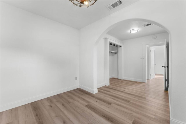 830 W St, Redding, CA 96001 - unfurnished bedroom with arched walkways, light wood-style floors, and a closet