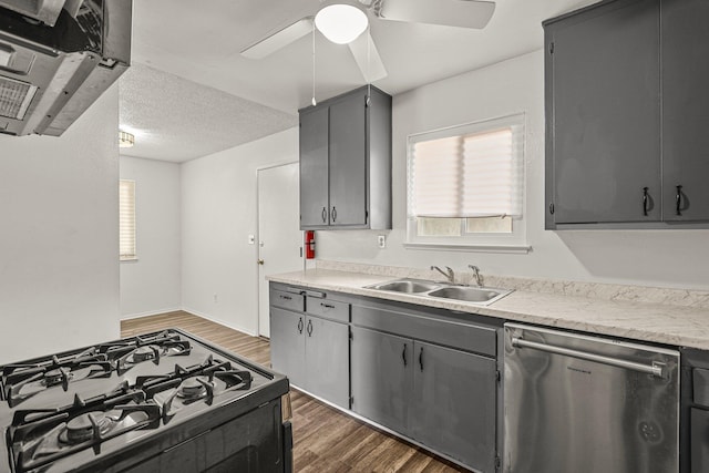 2092 Phobos Ct, Redding, CA 96002 - kitchen with stainless steel dishwasher, gas range oven, dark wood-type flooring, a ceiling fan, and light countertops