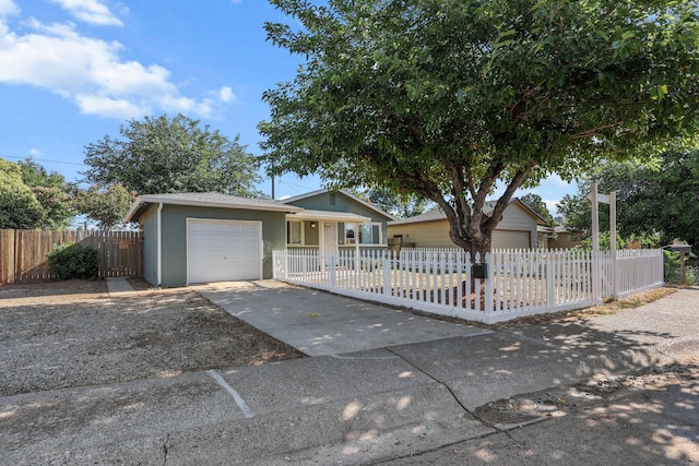 2092 Phobos Ct, Redding, CA 96002 - ranch-style house featuring an attached garage, asphalt driveway, a fenced front yard, and stucco siding