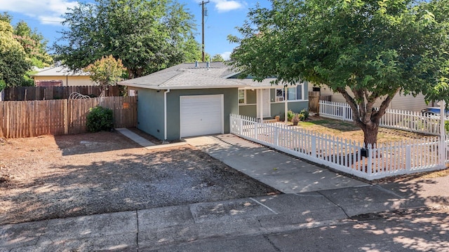 2092 Phobos Ct, Redding, CA 96002 - view of front of home with an attached garage, a fenced front yard, a shingled roof, and stucco siding