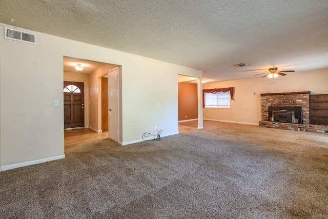 6781 Reflection St, Redding, CA 96001 - unfurnished living room featuring carpet flooring, a ceiling fan, a textured ceiling, and a brick fireplace