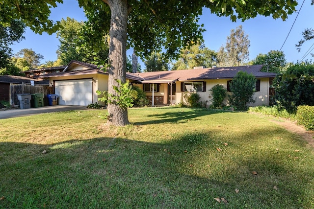 6781 Reflection St, Redding, CA 96001 - ranch-style house with asphalt driveway, an attached garage, and stucco siding